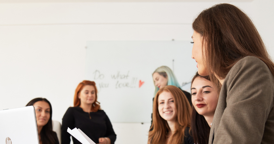 woman viewing hr compliance checklist with team in background