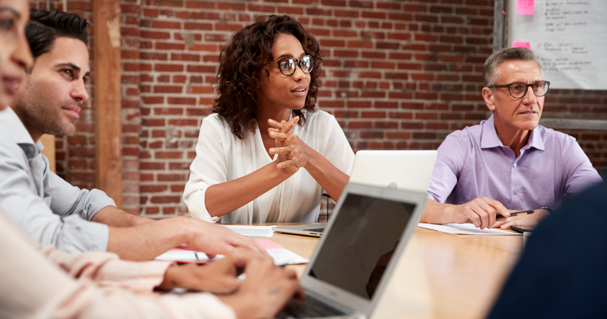 woman viewing hr compliance checklist with team in background