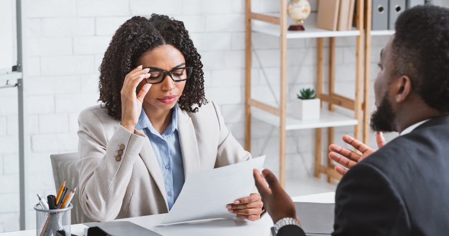 hr_admin_services_0019_Layer 3 woman viewing hr compliance checklist with team in background