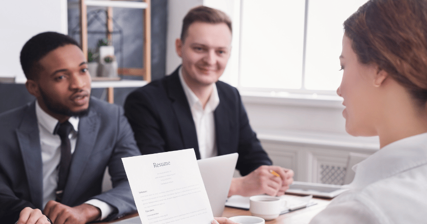 hr_admin_services_0019_Layer 3 woman viewing hr compliance checklist with team in background