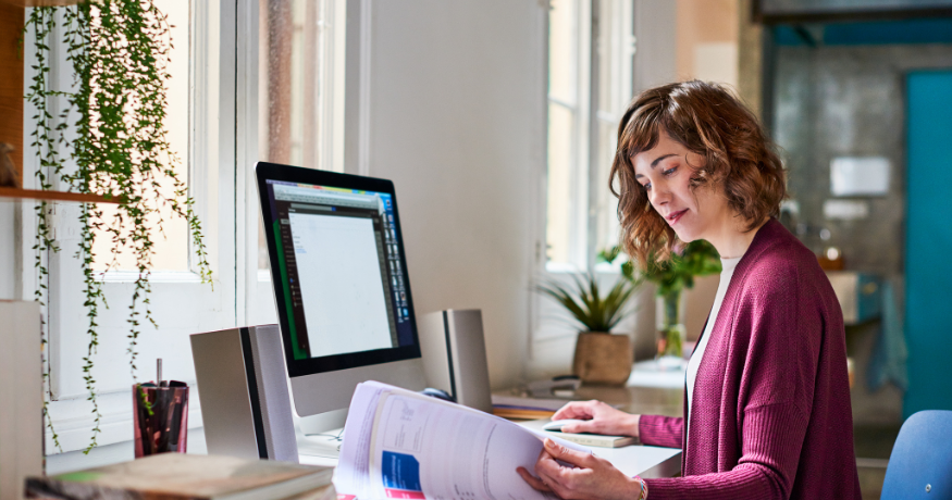 hr_admin_services_0019_Layer 3 woman viewing hr compliance checklist with team in background