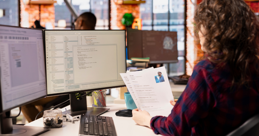 hr_admin_services_0019_Layer 3 woman viewing hr compliance checklist with team in background
