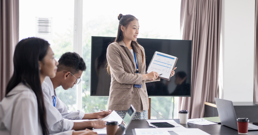 hr_admin_services_0019_Layer 3 woman viewing hr compliance checklist with team in background