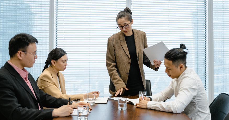 hr_admin_services_0019_Layer 3 woman viewing hr compliance checklist with team in background